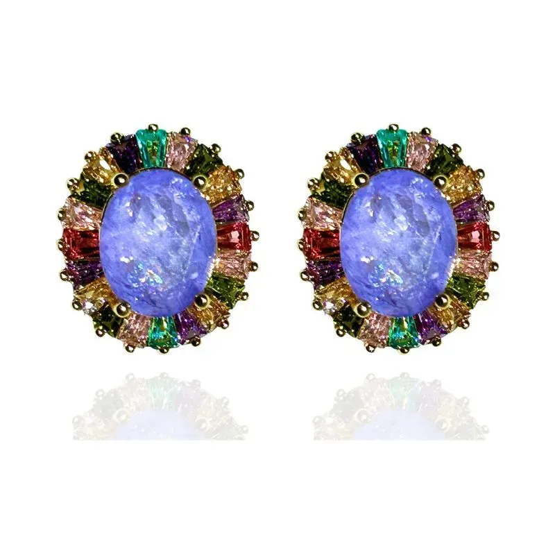 BRINCO OVAL COM BAGUETES EM VOLTA DA PEDRA